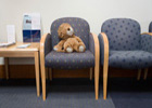 Teddy bear sitting in an office chair