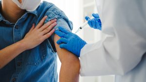 Person being vaccinated by a medical professional.