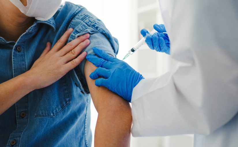 Person being vaccinated by a medical professional.
