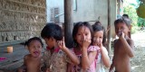Cambodian children show off their purple marked pinkies, showing that they are protected from measles and rubella, during an immunization campaign in 2013. (Photo courtesy of Sue Chu, CDC.)