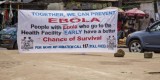A banner encouraging people suffering from Ebola to go immediately to a health center for treatment is seen on a sidewalk in the city of Freetown, Sierra Leone, Thursday, Aug. 7, 2014. While the Ebola virus outbreak has now reached four countries, Liberia and Sierra Leone account for more than 60 percent of the deaths, according to the World Health Organization. The outbreak that emerged in March has claimed at least 932 lives. (AP Photo/Michael Duff)