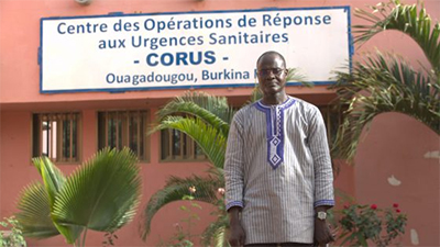 Dr. Yameogo in front of the Public Health Emergency Operations Center of Burkina Faso.