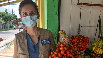 Dr. Juliana de Fatima da Silva hold fruit she received from grateful participants in the COVID-19 research study in Parintins, Brazil.