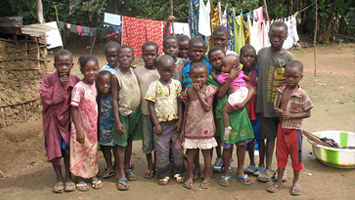 Curious children gather when CDC & county health teams visit their village.