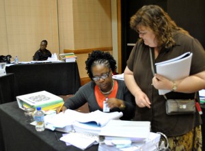 Cheryl Westcott from the British Virgin Islands receives guidance from Crawford during a 2012 ICD-10 Mortality Coding workshop that took place in Trinidad and Tobago. 