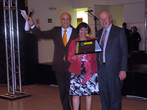 Marjorie Greenberg receives an award from Dr. Bedirhan Ustun from the WHO and Dr. Richard Madden.