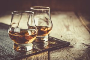 Whiskey with ice in glasses.