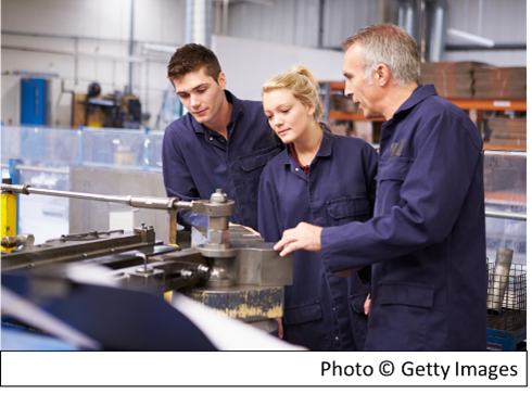 3 workers examining a machine