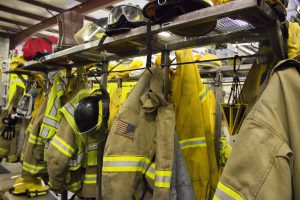 Inside fire station with firefighting suits