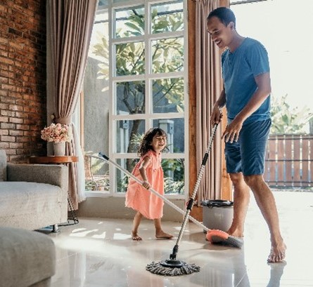 father and young daughter cleaning the floor