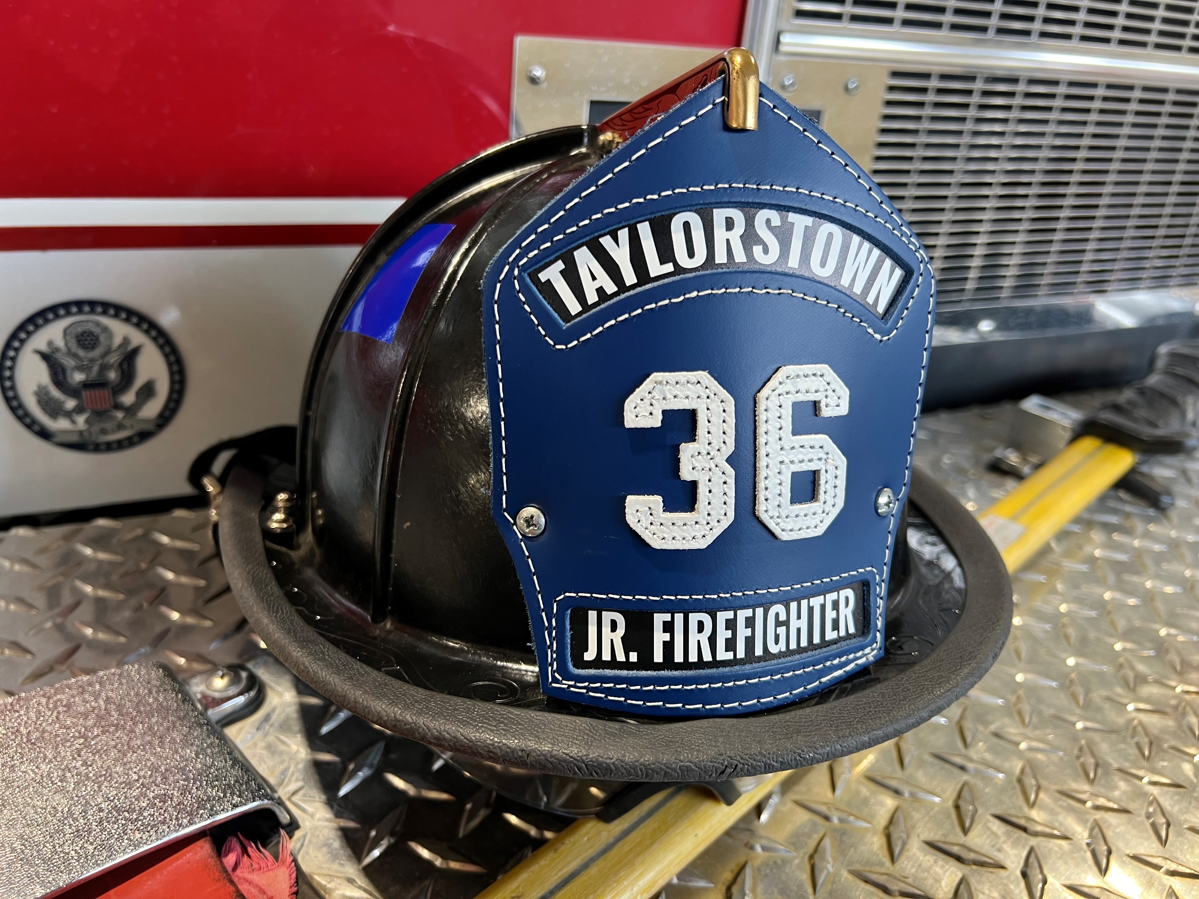 photo of a fire fighter helmet with the words Taylorstown Jr. Firefighter, number 36.