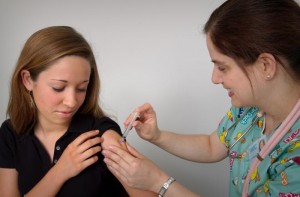female patient receiving vaccination from nurse