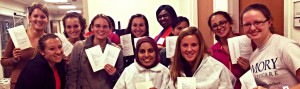 Emory students holding up sheets of paper