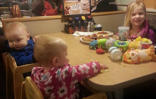 3 small children eating in thier PJs