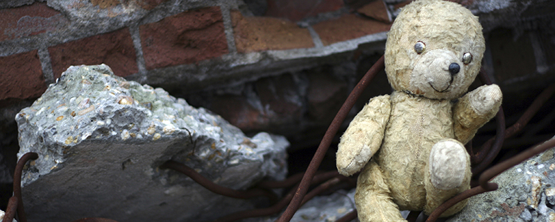 Teddy bear in rubble