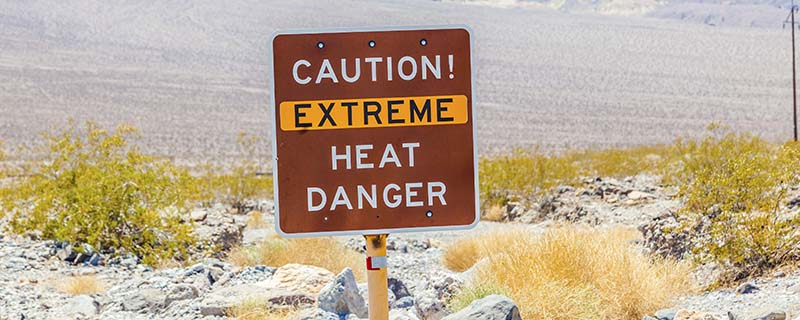 A road sign in Death Valley warning travelers of Caution Extreme Heat Danger