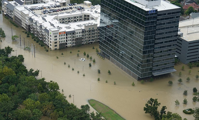 Photo of a flooded apartment complex and office building during Hurricane Harvey.