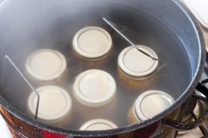 Glass jars in a hot water bath.