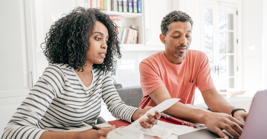 A middle-aged man and woman discussing finances.