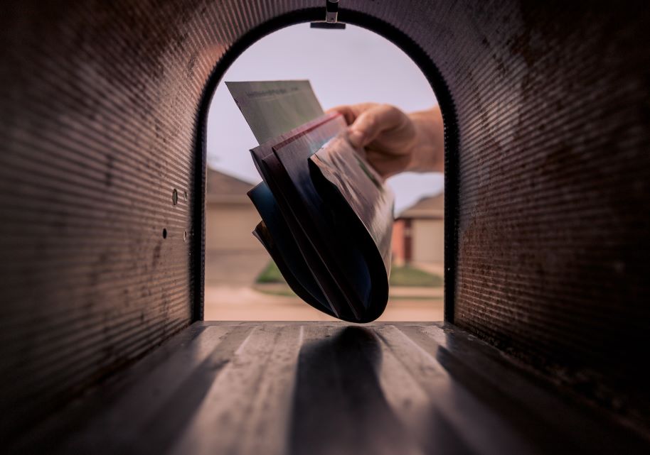 A person takes mail from mailbox.