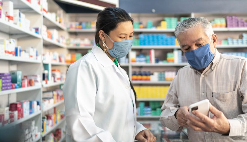 Female pharmacist helping a senior customer.