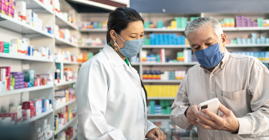 Female pharmacist helping a senior customer.