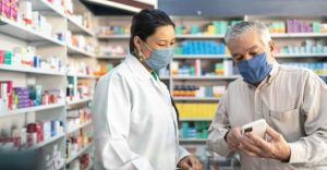 A pharmacist talking with a customer.