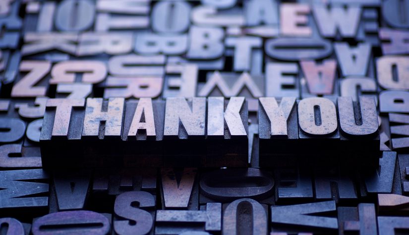 The words "thank you" spelled out in typesetting blocks.
