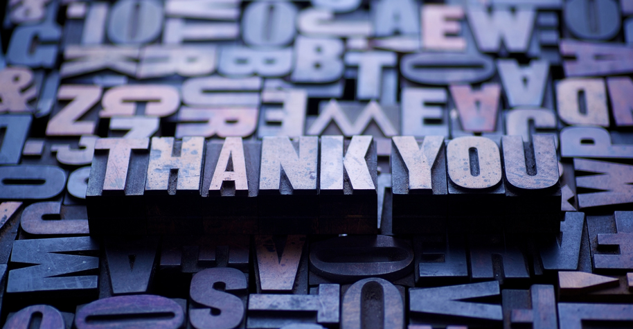 The words "thank you" spelled out in typesetting blocks.