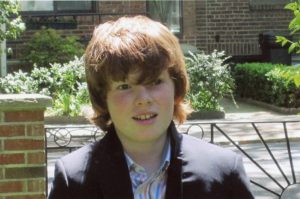 Young boy standing outside