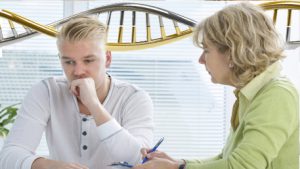 a man talking to a genetic counselor about genetic results with DNA in the background