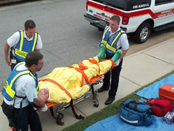 emergency responders with a patient on a stretcher