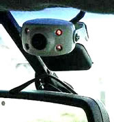 Digital security camera head mounted over the rear-view mirror in a Winnipeg taxicab. 