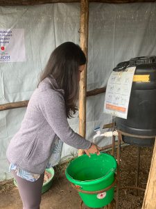Samira Sami practices good Infection Prevention and Control measures by using a handwashing station at the Cyanika Border, a major crossing point between Uganda and Rwanda.