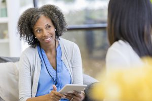 Patient navigator or counselor listens to patient