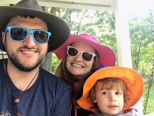 Ginny and her family with hats and sunglasses. 