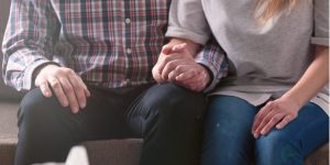 close-up of couple sitting and holding hands