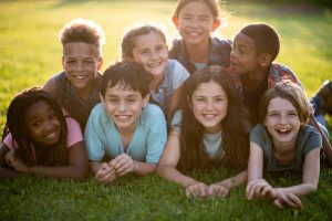 group of children laying in the grass