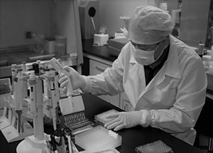 A man dress in personal protective equipment in a laboratory.