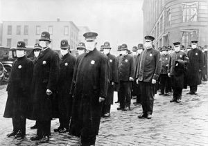 Policemen patrol the streets in masks in Seattle to ensure public safety.