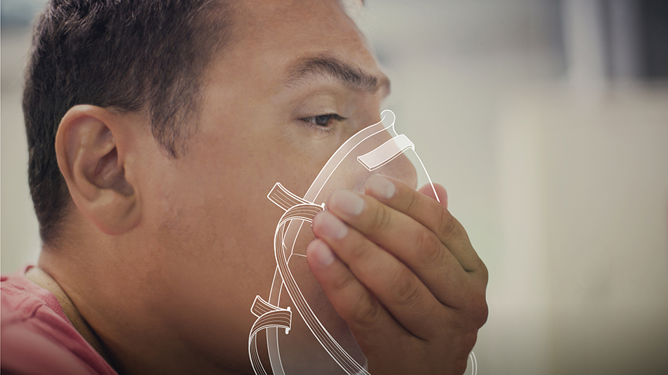 Close-up photo of a man putting on a respirator.