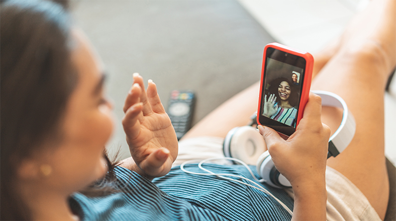 Young women video chat with each other.